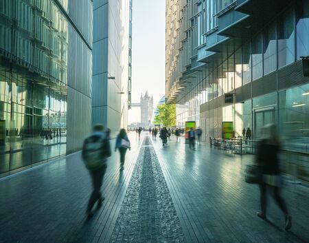 business people, modern buildings and Tower Bridge, London, UKの写真素材
