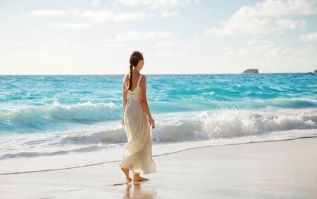 walking young woman, Seychelles beachの写真素材