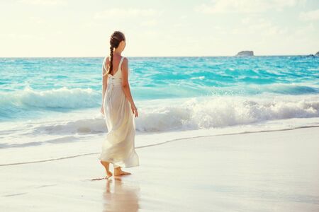 walking young woman, Seychelles beachの写真素材