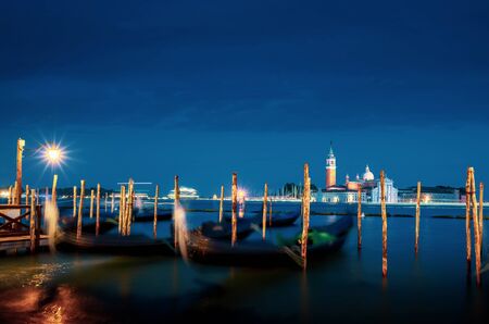 gondolal at night and San Giorgio Maggiore church, Venice, Italyの写真素材