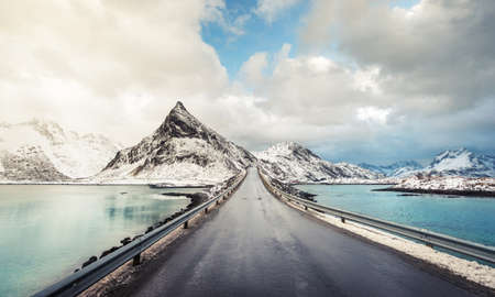Olstind Mount and asphalt road. Lofoten islands, spring time, Norwayの写真素材