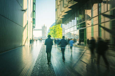 business people, modern buildings and Tower Bridge, London, UKの写真素材