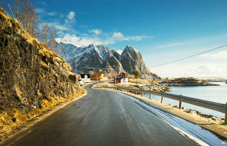 road with snow mountains and fisherman village background, spring time, Reine, Lofoten, Norwayの写真素材