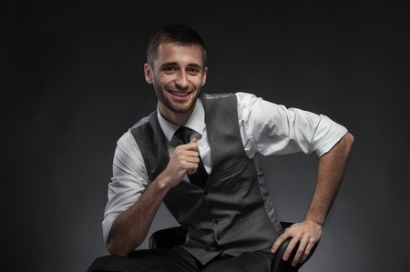 Hey There . happy businessman. Sitting Man Isolated on black  Backgroundの写真素材