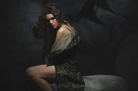 naked truth about the war. young girl in camouflage, with exposed parts of the bodyの写真素材