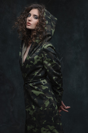 Military prisoner. A young girl in a military cloak , her hands tied behind her backの写真素材