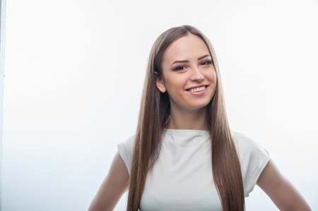 Waist up portrait of cheerful girl. Isolated on a white backgroundの写真素材