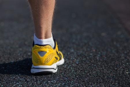 Close up of male leg in sneaker. The sportsman is ready to run. There is copy space in right sideの写真素材
