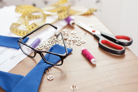 Close up of design things and eyeglasses lying on the table