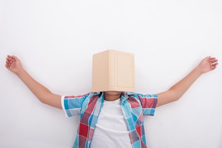 Cute boy is lying on floor and sleeping. He is exhausted of learning. The book is situated on his face. Isolated on backgroundの写真素材