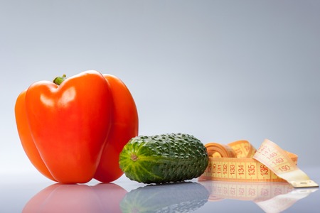 Close up of cucumber and tomato. Isolated on blue backgroundの写真素材