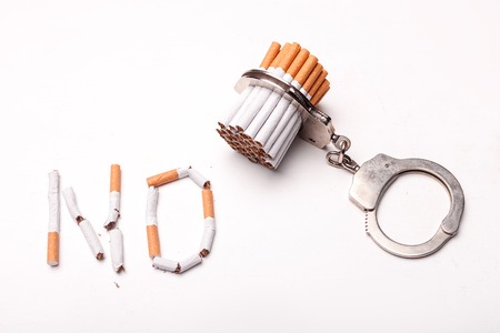 No smoking. Close up of cigarettes attached to manaclesの写真素材