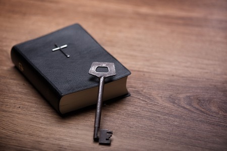 Close up of the Bible with a kea on the table. This literature is the key of new lifeの写真素材