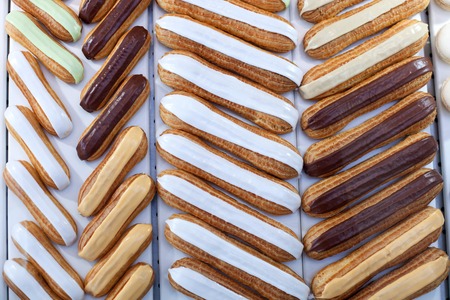 Close up of sweet fancy cakes with cream inside on the trayの写真素材