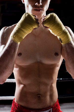 Cheerful boxing champion is fighting with his opponent. He is standing with confidenceの写真素材