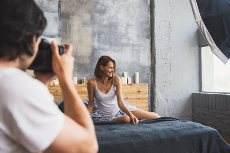 Photographer on a shooting day in studio with modelの写真素材