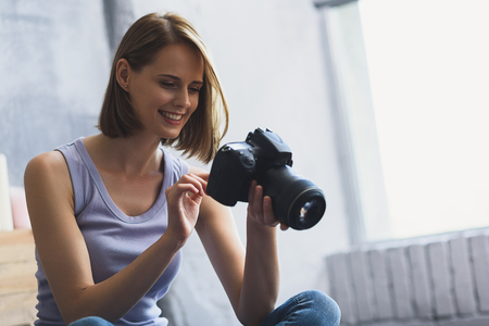 it looks great, young woman enjoying photo she madeの写真素材