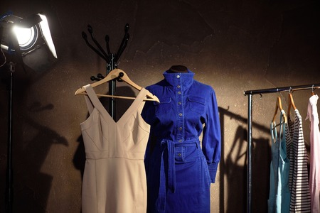 Trendy female dresses on mannequin and hanger backstageの写真素材