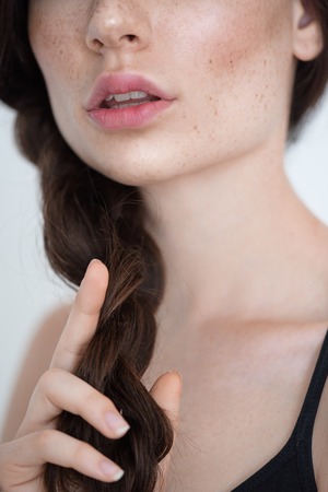 skin and hair care concept, close up of a neck of freckled pretty girlの写真素材