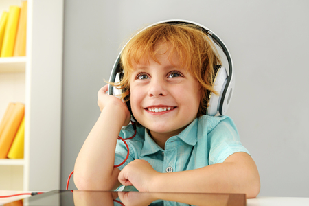 learning and next generation concept, young boy dreaming in headphonesの写真素材