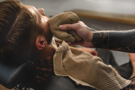 close up of barber wiping shaving gel, concept of shavingの写真素材