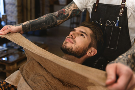 hot and cold towels in a old style barbershop, ritual and concept of shavingの写真素材