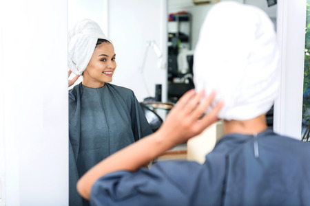 selective focus of a woman in mirror after bathの写真素材