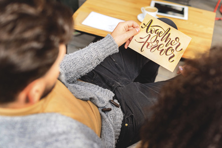 man holding a piece of paper with text together foreverの写真素材