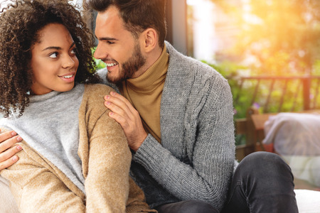 women looking at her fiance with love while they resting indoorsの写真素材