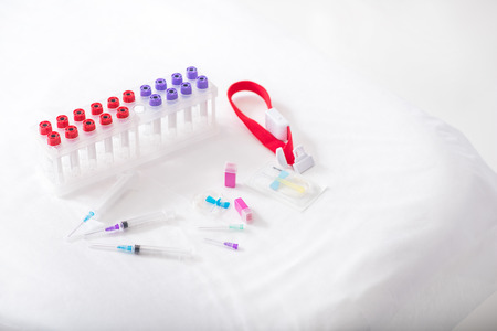 Close-up of medical set for blood test. Flasks, syringes, catheter and elastic bandの写真素材