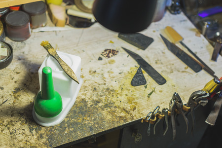 high angle view of an old messy desk of a coblerの写真素材