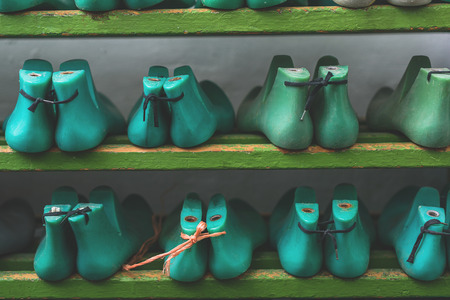 blue and green plastic pads on a wooden shelfの写真素材