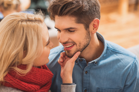 I love you. Relaxed young loving couple is hugging and flirting at home. They are smilingの写真素材