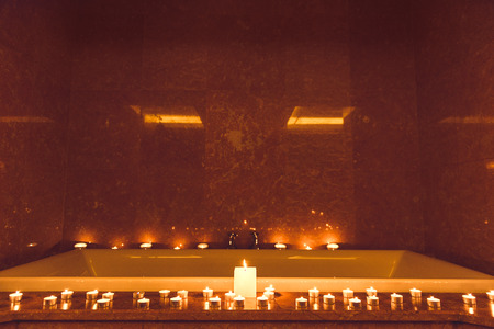 Large bath with candles around for relaxation and luxuryの写真素材