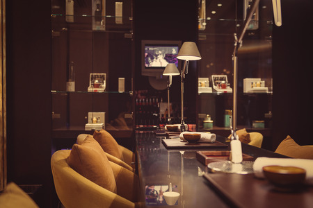 Comfortable chairs, towels and bowls on table in relaxation room at wellness centerの写真素材