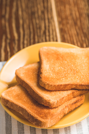 Fried toasts on yellow plateの写真素材