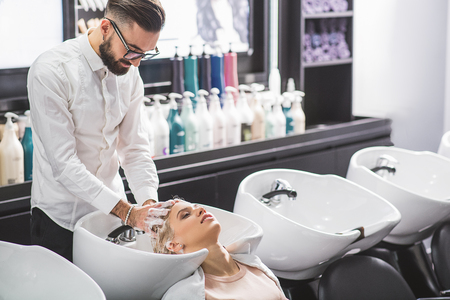 Professional stylist is working with a clientの写真素材