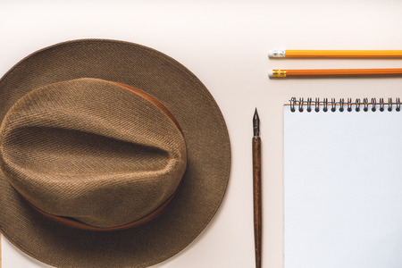 Brown hat near writing materialsの写真素材