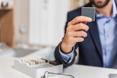 Shop assistant showing product for interiorの写真素材