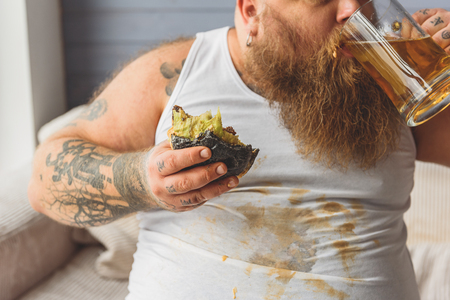 Thick male fatso enjoying beerの写真素材