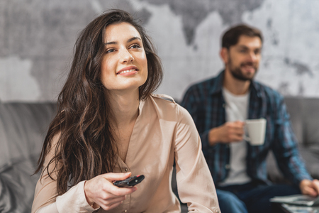 Carefree husband and wife watching tvの写真素材
