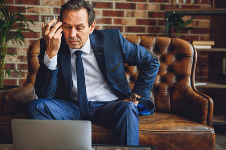 Mature businessman trying to be concentratedの写真素材