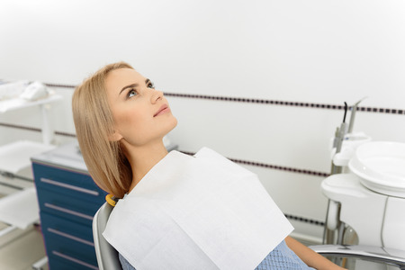 Waiting young woman lying at dentist roomの写真素材