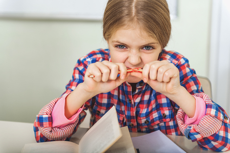 Tired girl in light classroomの写真素材
