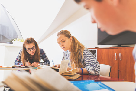 Interested teenagers in light classroomの写真素材