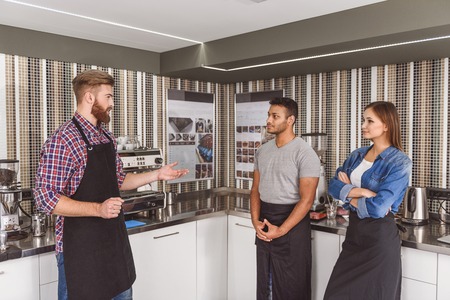 Smiling barista going to teach visitorsの写真素材