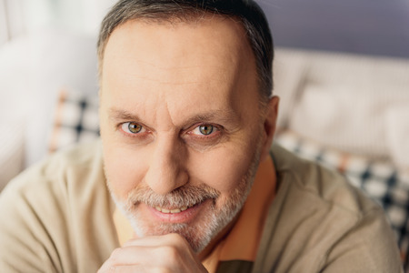 Joyful grandfather resting at home