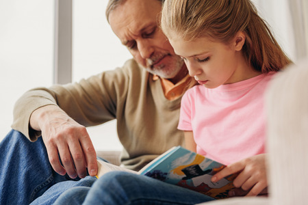 Friendly family entertaining with book togetherの写真素材