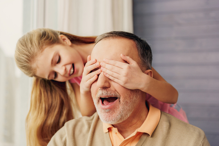 Child playing with grandparent at homeの写真素材
