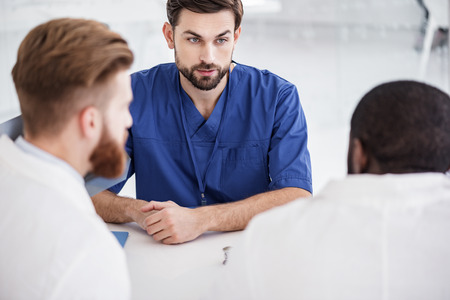 Serene physician telling with affiliates at conferenceの写真素材